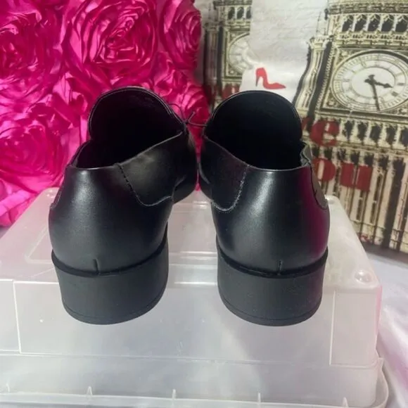 DKNY Black Slip On Loafers br With‎ silver buckle logo, women's size 11