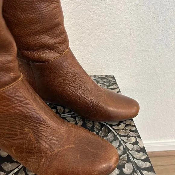 Whiskey Brown leather knee-high riding boots with a buckle to adjust calf