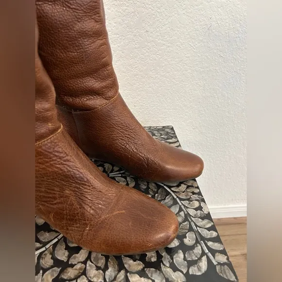 Whiskey Brown leather knee-high riding boots with a buckle to adjust calf